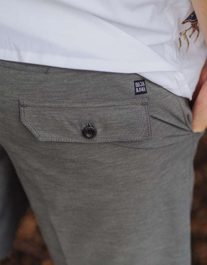 Close-up of the Baja Llama Magellan Explorer Shorts in Charcoal, highlighting the secure buttoned back pocket and brand label detail.