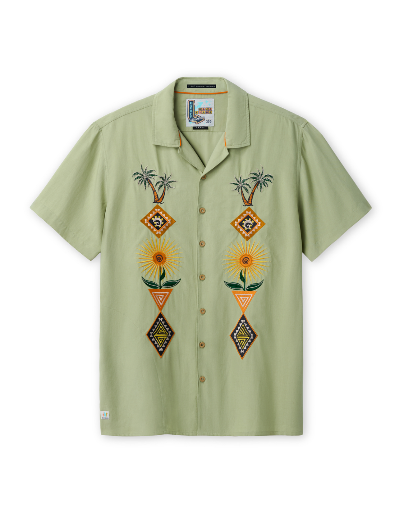 Front view of the Baja Llama 'Oasis Geometry' One-Off relaxed-fit short-sleeve button-up shirt in a soft sage green, featuring two vertical panels of symmetrical, colorful embroidery depicting palm trees, suns, and geometric diamond shapes.