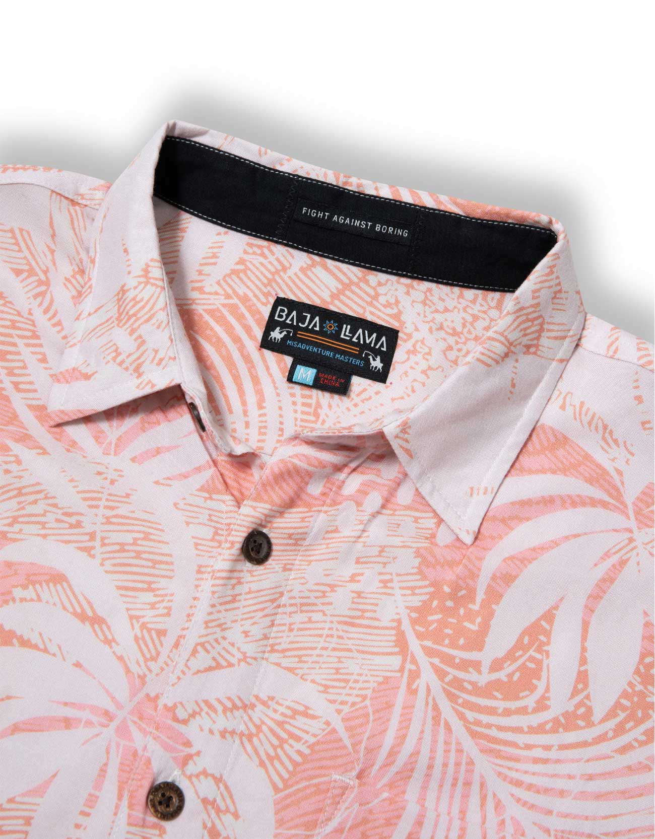 Peach colored button up shirt with tropical palm leaves print 