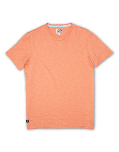 Baja Llama Solid Burnt Salmon Slub Pima Tee – Burnt coral crewneck T-shirt made from ultra-premium Peruvian cotton with textured slub finish – Displayed flat with visible woven neck label and signature Sloth Llama patch near hem – Lightweight, breathable, and eco-friendly casual wear for men