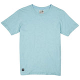 Front flat-lay view of the Baja Llama Solid Porcelain Blue Pima Slub Tee, featuring a light blue crewneck t-shirt with a distinct slub texture and a small square brand logo patch on the bottom left hem.