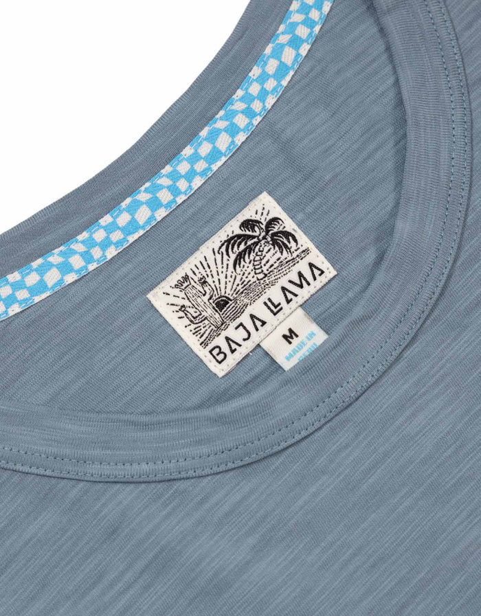 Neck label close-up of slate blue Solid Slub Pima tee with Baja Llama tag and blue check neck tape