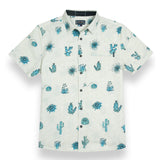 Tan button up shirt with various cactus print in turquoise