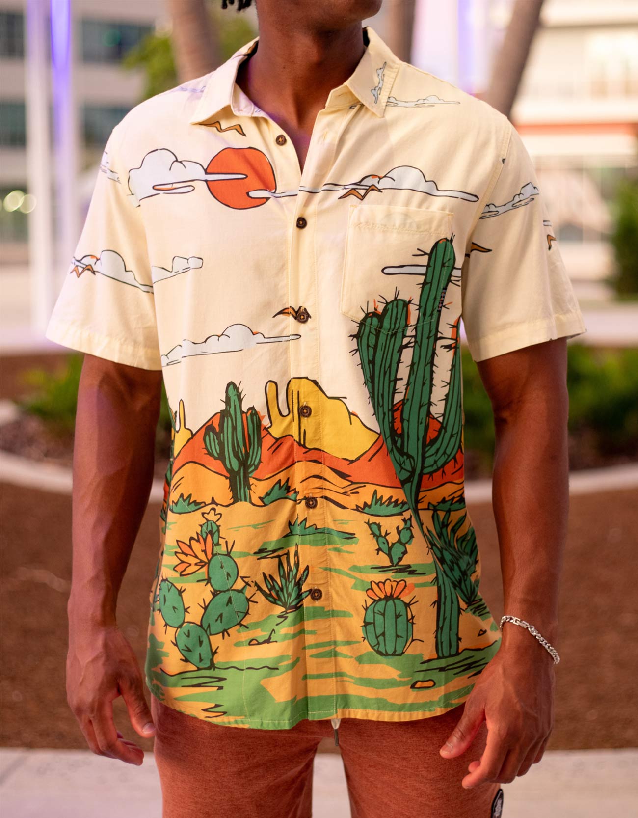 Cream short sleeve button up shirt featuring desert landscape and cactus print