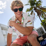 Baja Llama The BBQ Shirt 7-Seas Relaxed Fit Button Up white short sleeve shirt worn by a smiling model outdoors.