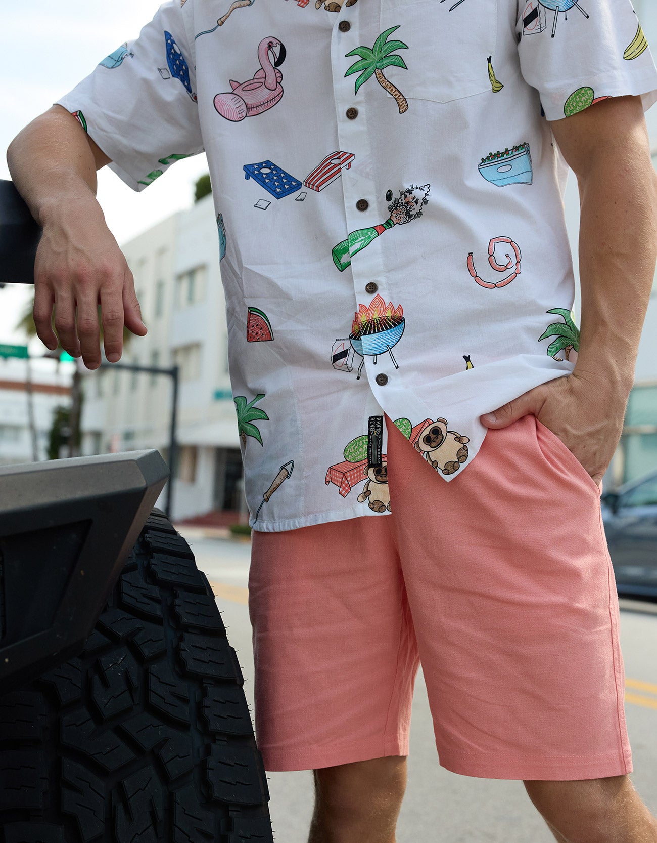 Close-up of Baja Llama The BBQ Shirt 7-Seas Relaxed Fit Button Up showing white fabric with colorful barbecue print.
