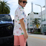 Baja Llama The BBQ Shirt 7-Seas Relaxed Fit Button Up white short sleeve shirt styled on a model standing by a custom vehicle.