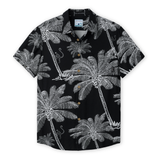 Front view of THE CANOPIES ARE ALIVE - NIGHTHAWK™ RELAXED FIT BUTTON UP from Baja Llama, a black short-sleeve shirt featuring an intricate white hand-drawn print of palm trees and monkeys.