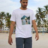 Baja Llama The Girl In Ipanema Primo Graphic Tee white short sleeve t-shirt worn by a model on a tropical beach.