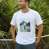 Baja Llama The Girl In Ipanema Primo Graphic Tee white short sleeve t-shirt worn by a smiling model outdoors.
