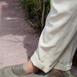 Close-up of Baja Llama Too Breezys Linen Pants Natural Beige showing cuffed hem detail and slip-on shoes.