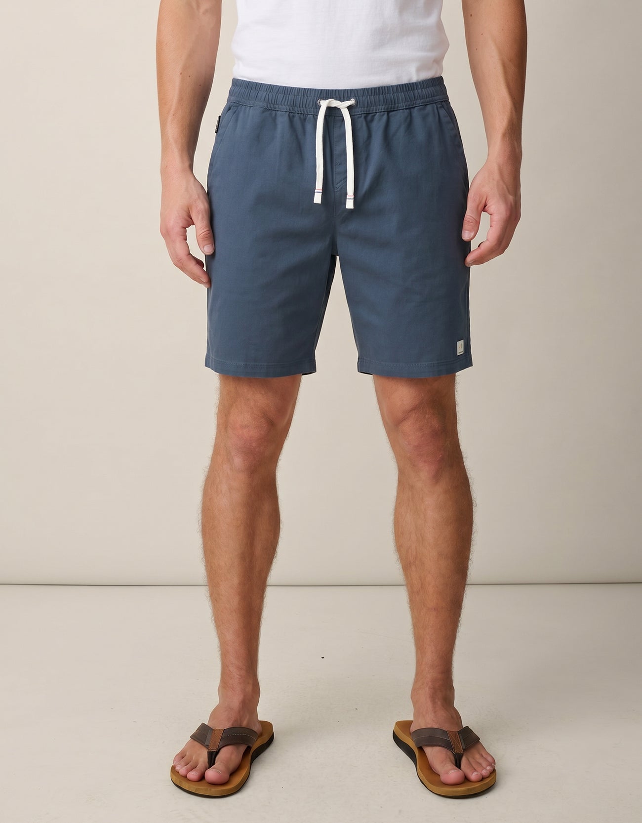 Man wearing Baja Llama dark slate stretch cotton shorts with white drawstring waist