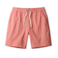 Coral pink linen shorts with a drawstring on a white background