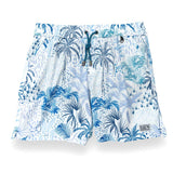 White men's swim trunks featuring tropical palm trees and taro in different hues of blue.